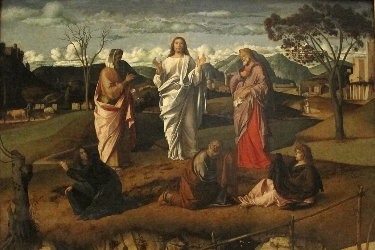 Christ in shining white stands on a hilltop between Moses and Elijah, while three disciples fall to the ground below in a wide landscape.