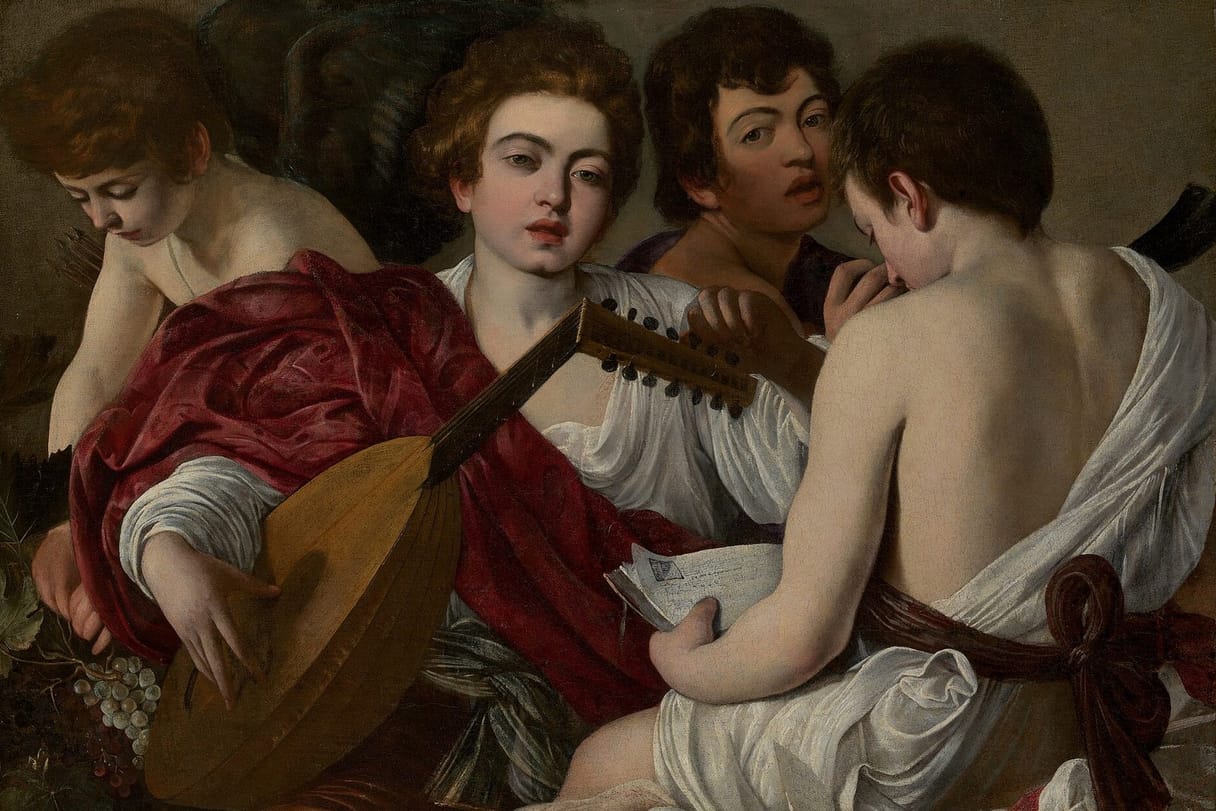Four young musicians crowd together: one tunes a lute, one studies a sheet of music, one looks out at the viewer, and a winged Cupid reaches for grapes.