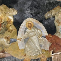 Christ in shining white robes stands on the broken gates of hell and pulls Adam and Eve up out of their tombs by the wrists.