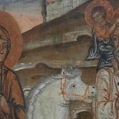 Mary, in a dark blue robe and brown mantle, rides a white mount while Joseph walks beside her carrying the young Jesus on his shoulders, below a walled city on a hill.