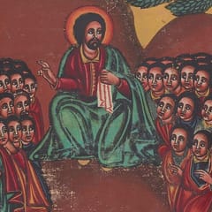 Christ, with a red halo and a green mantle, sits on a hillside and raises one hand as he teaches, while crowds of listeners gather close on either side.