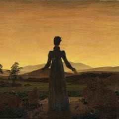 A woman seen from behind stands on a path with her arms opened toward a glowing golden sky over dark hills.