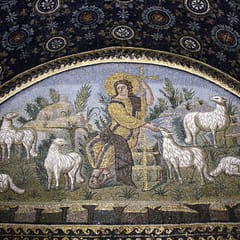 A youthful Christ in golden robes sits among white sheep on a rocky meadow, holding a tall cross, in a lunette of glittering mosaic.