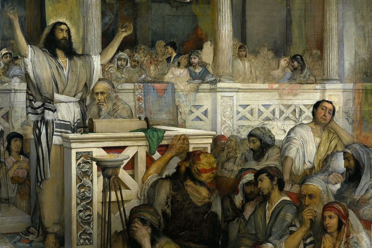 Jesus, wrapped in a striped prayer shawl, raises his arms as he teaches in a synagogue crowded with listening men and women.