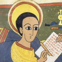 A young evangelist with a large golden halo and wide dark eyes writes lines of Ge’ez script on an open scroll, wrapped in a blue mantle over a yellow tunic, against a green ground.