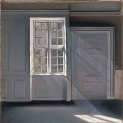 Sunlight slants through a tall window into a quiet, empty gray room, falling in bright patches on the bare floor.