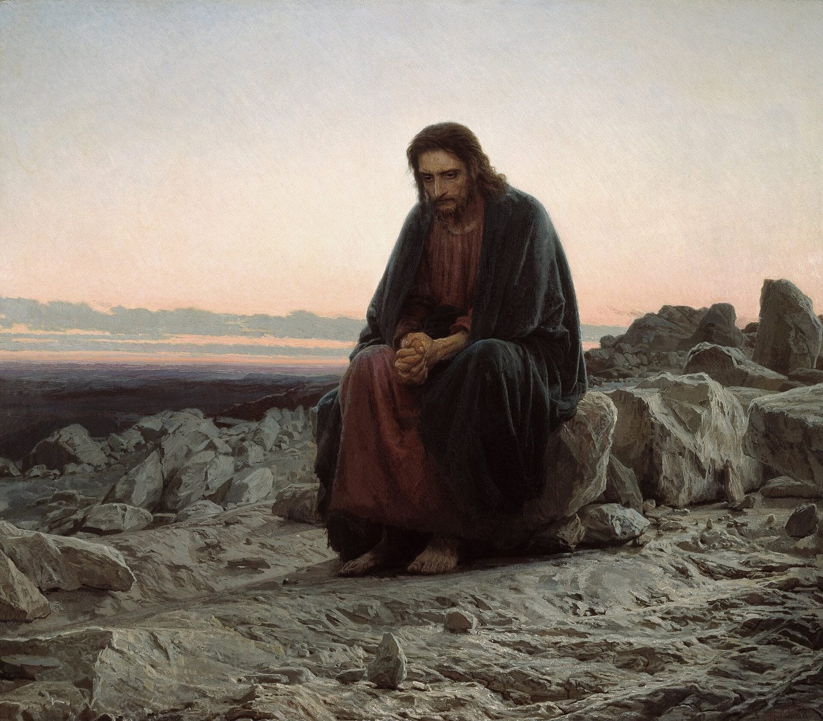 Jesus sits alone on a rock in a stony desert at dawn, his hands clasped tightly in prayer and thought.