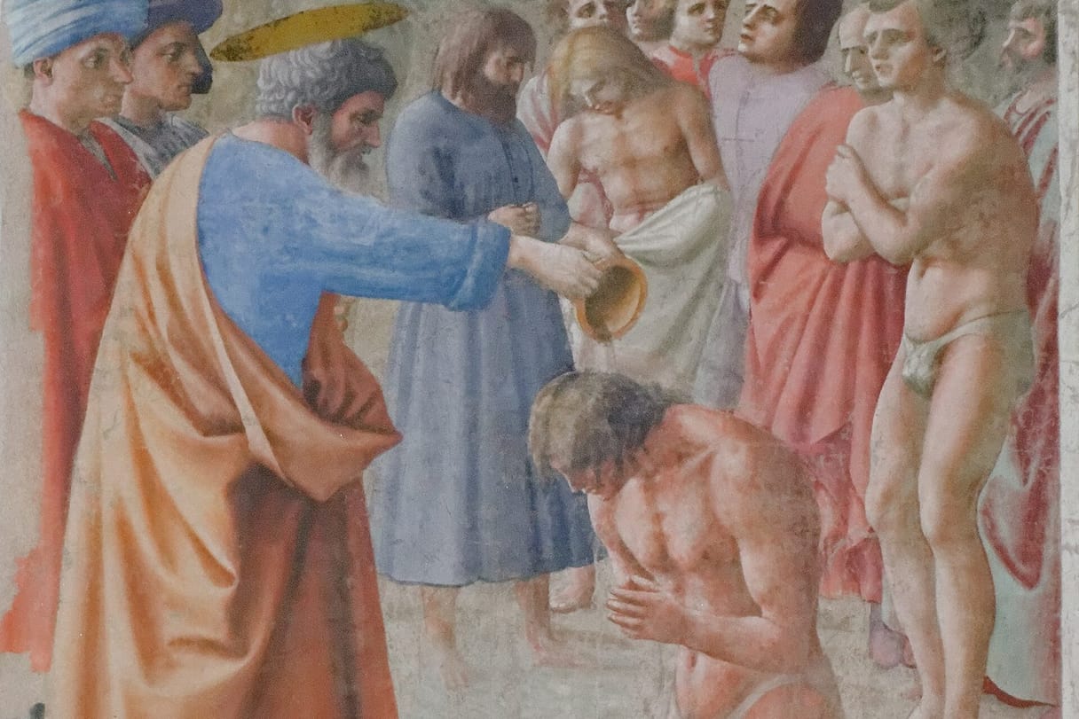 Saint Peter, haloed and wearing a blue robe and orange cloak, pours water from a bowl over the head of a kneeling man, while other men wait their turn, one shivering with his arms crossed.