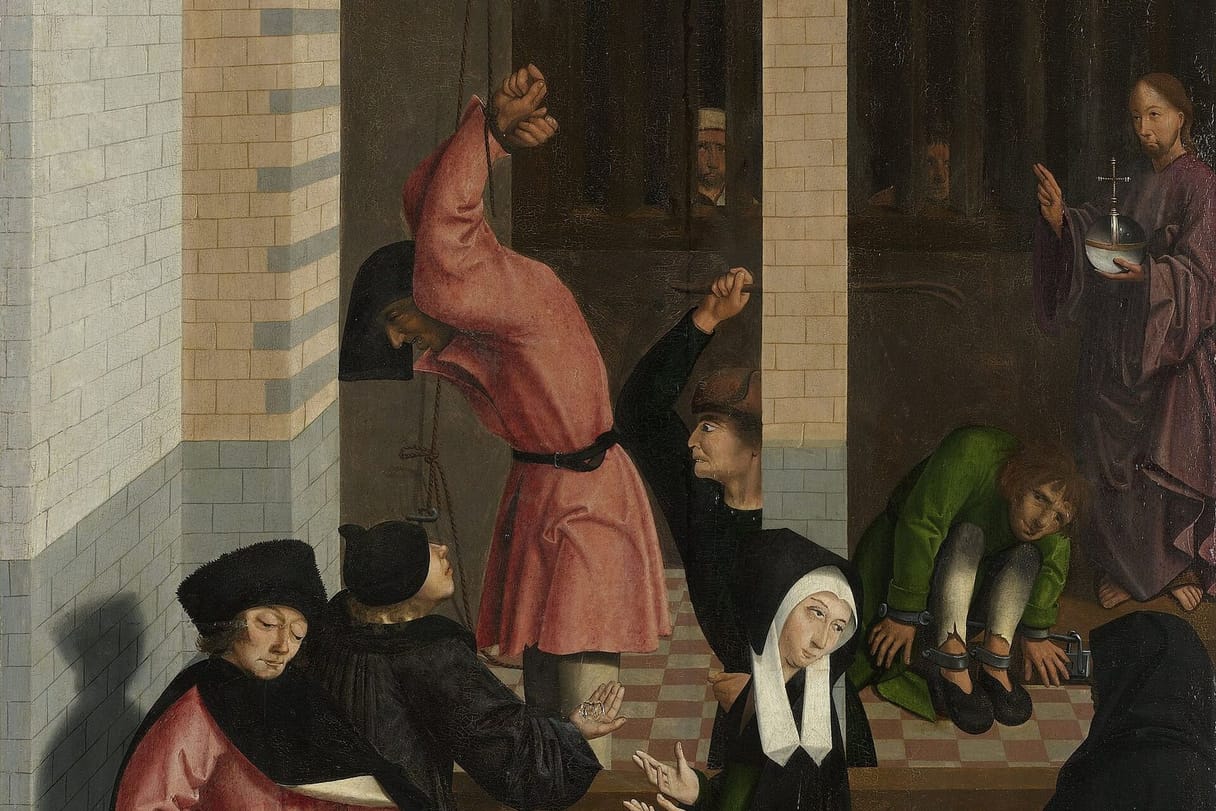 Visitors in dark robes offer coins over the railing of a prison yard, where a prisoner hangs by his bound wrists as a jailer raises a stick, another sits with his ankles locked in irons, and faces look out from behind bars; Christ stands among the prisoners, raising his hand in blessing.