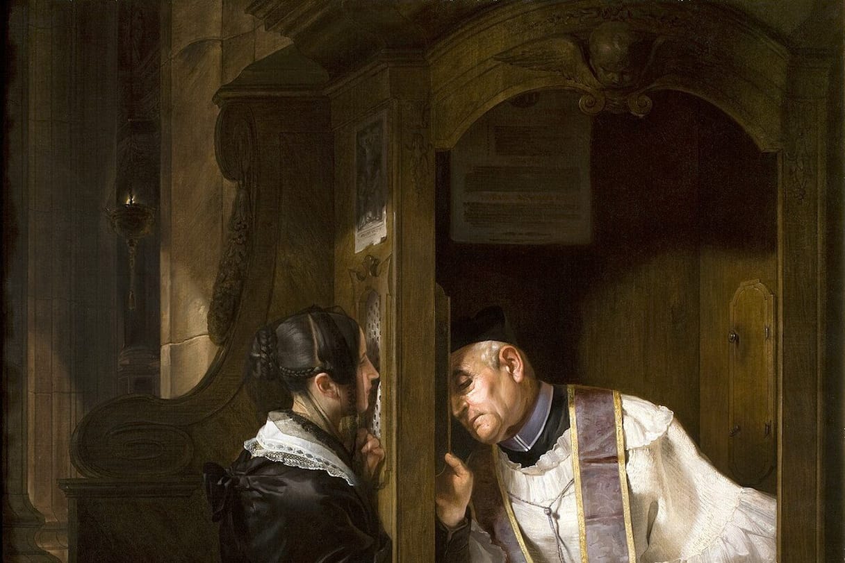 A woman kneels at a wooden confessional, speaking quietly through the screen to a priest in a white surplice who leans in to listen.