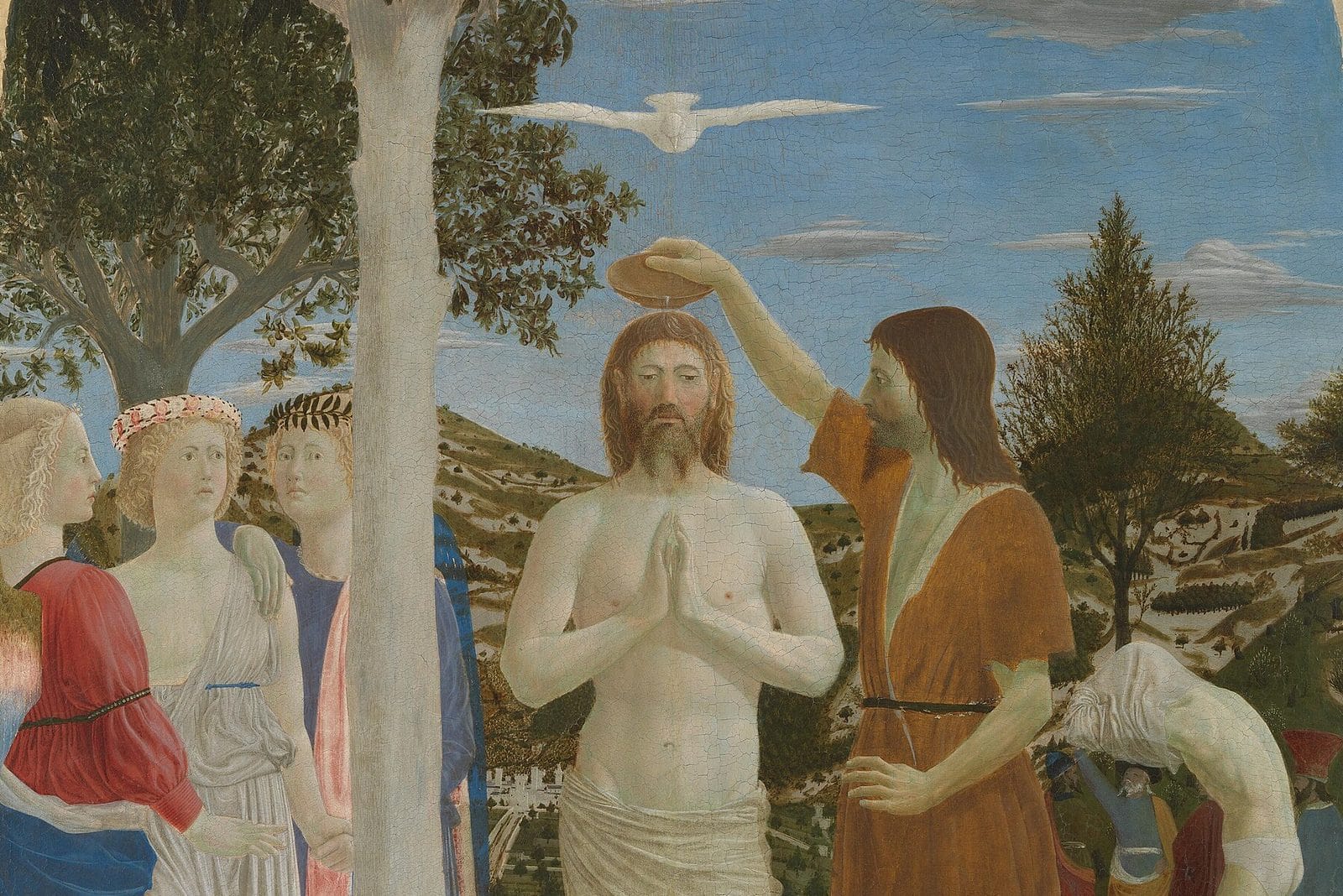 John the Baptist pours water over the head of Jesus, who stands with hands joined in a shallow stream, as a white dove hovers above and three angels watch beside a tree.
