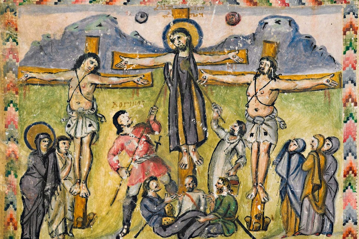 Christ, in a long purple robe, hangs on the cross between two thieves under the sun and moon; one soldier pierces his side with a spear and another lifts a sponge, soldiers cast lots at the foot of the cross, and Mary, John, and the women watch from either side.