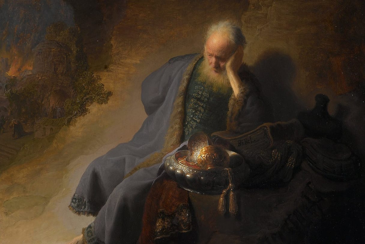 An old prophet in a dim cave rests his head on his hand beside a gleaming metal bowl, while a city burns in the distance.
