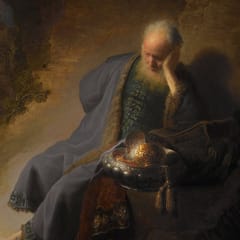An old prophet in a dim cave rests his head on his hand beside a gleaming metal bowl, while a city burns in the distance.