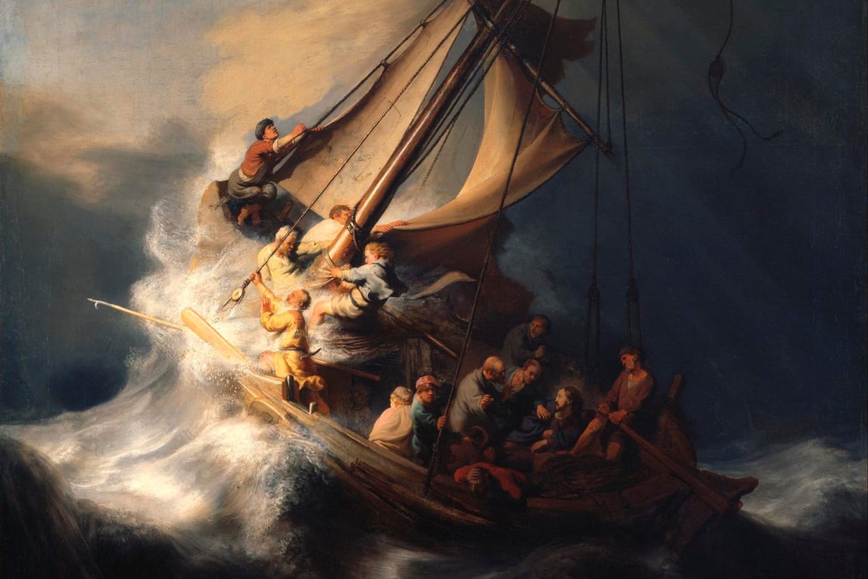 A small fishing boat pitches on a huge wave under a dark sky as the disciples struggle with the sail and ropes.
