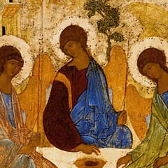 Three haloed angels with golden wings sit around a table bearing a single cup, their heads inclined toward one another.