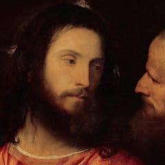 Jesus, in a red robe, looks calmly aside at a bald, bearded man who leans in close beside him.