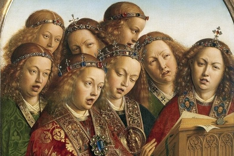 A close group of angels with long golden curls and jeweled circlets sing together, mouths open and brows furrowed in concentration, one turning the page of a songbook on a carved wooden lectern.