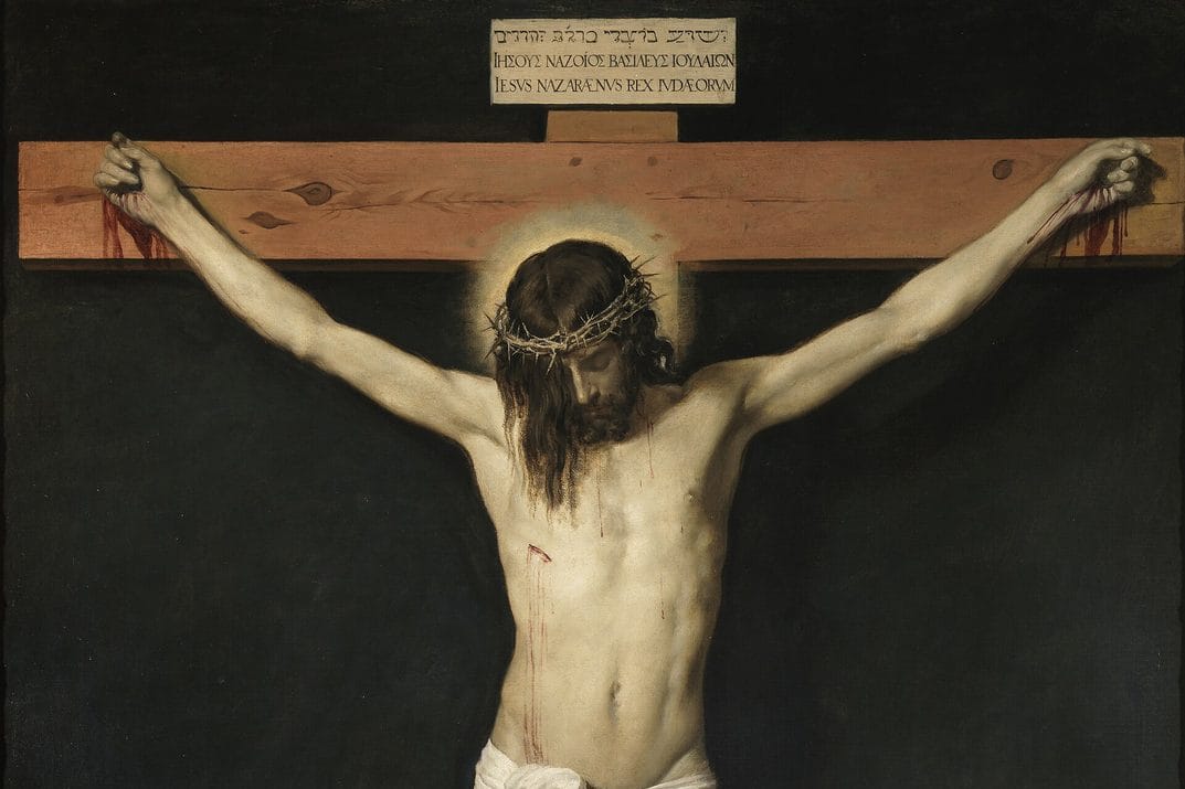Christ hangs on the cross against a plain dark background, his head bowed and partly hidden by his hair.