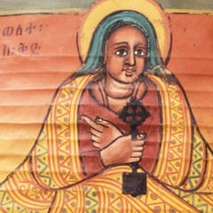 A haloed woman in a blue headscarf and a yellow patterned mantle sits facing us, holding a dark hand cross against her chest, beside her name written in Ge’ez.