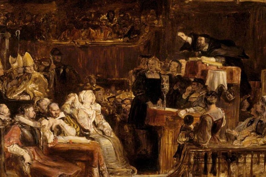 A bearded preacher in a black cap leans out of a high pulpit with his arm raised over a crowded church of nobles, bishops in white miters, and richly dressed women.